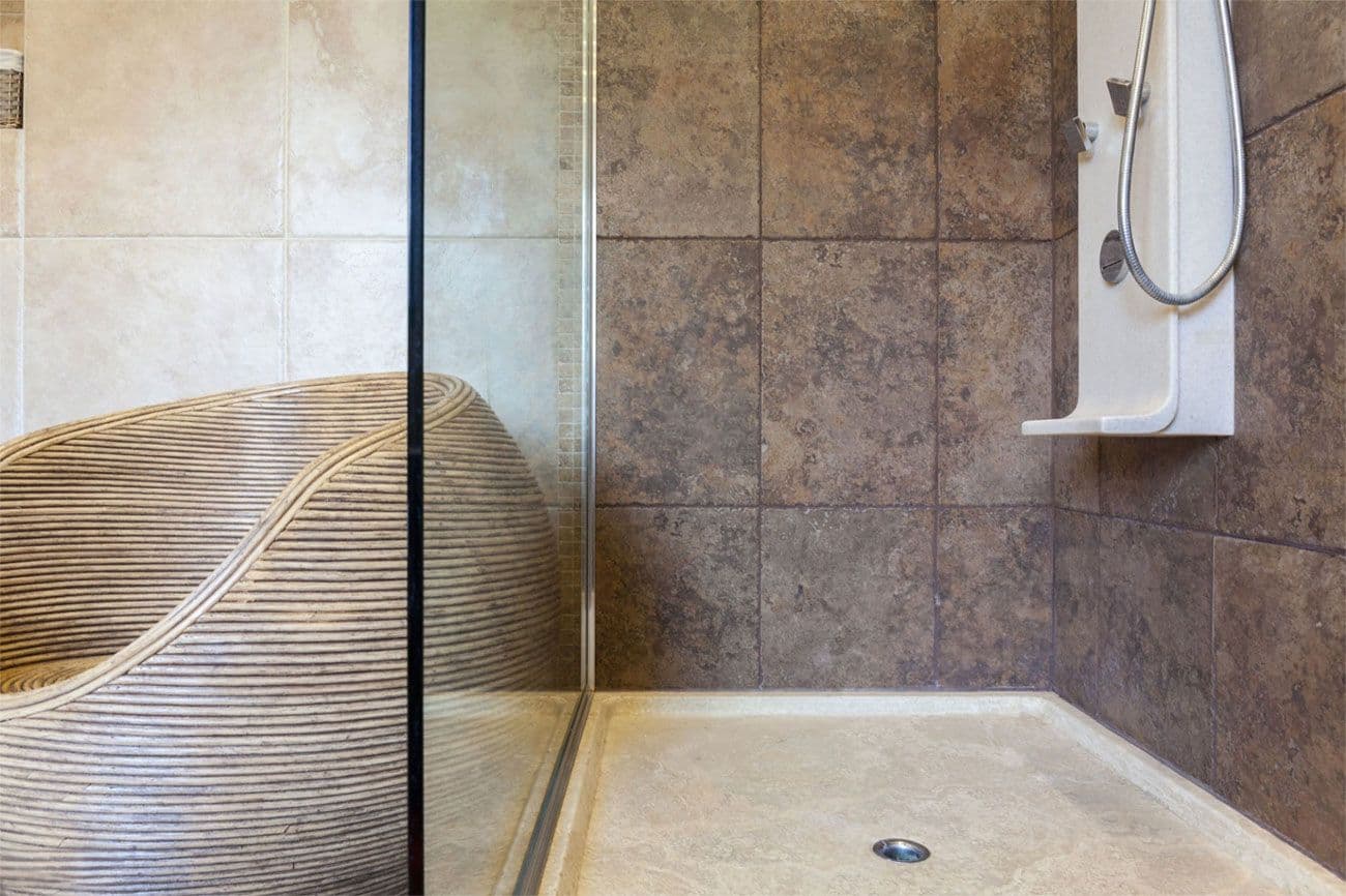 Walk in shower base with a center drain