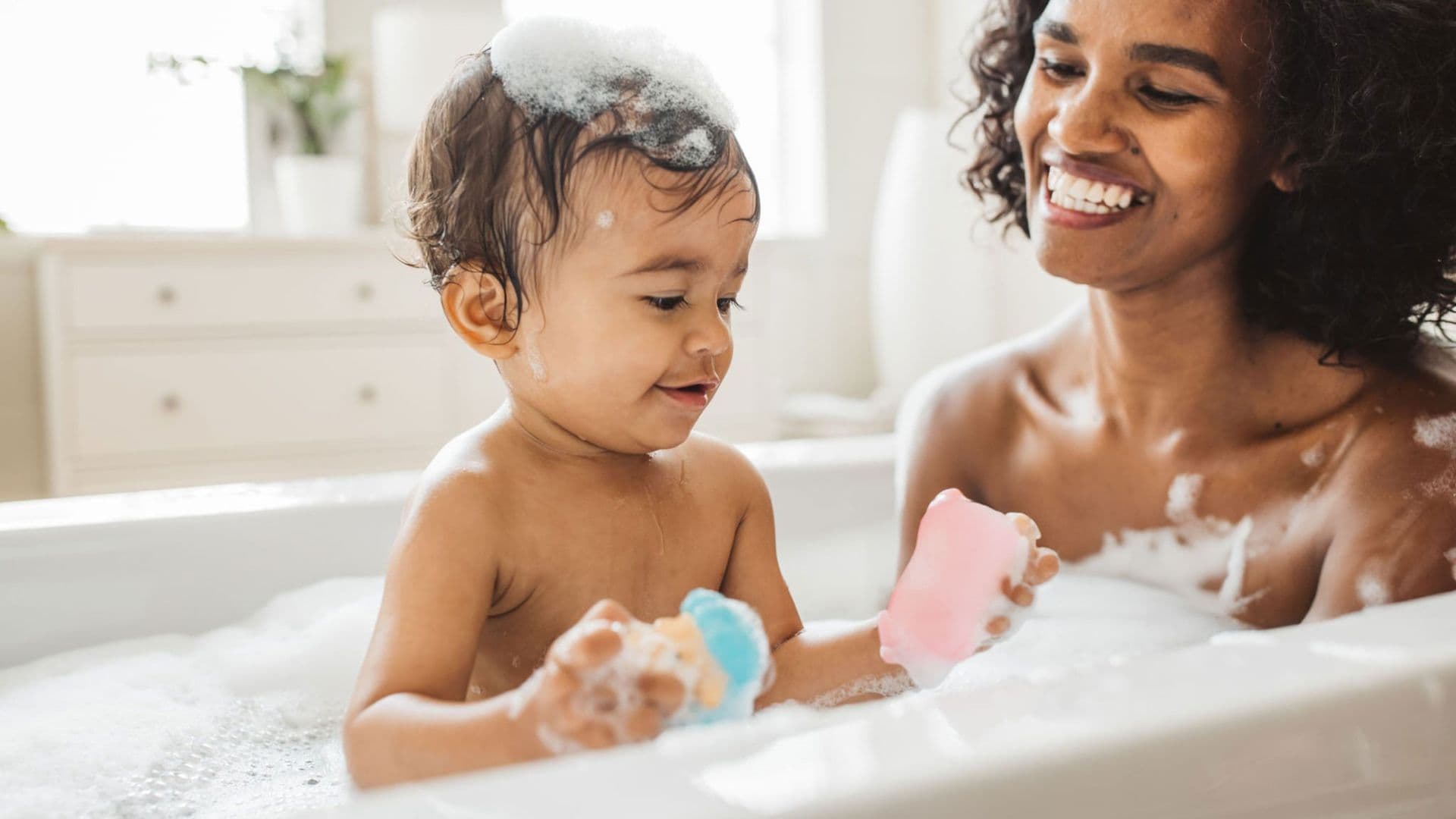 Happy Baby and Mother in Bath