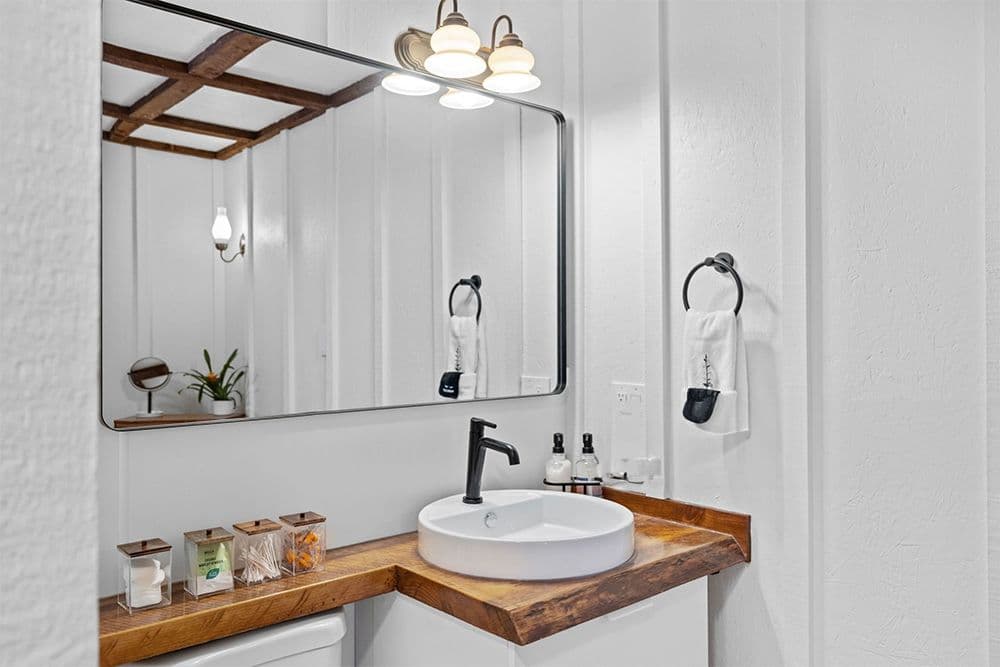 Modern Farmhouse Style Bathroom with jars and rough wood vanity top. Total Bath Systems